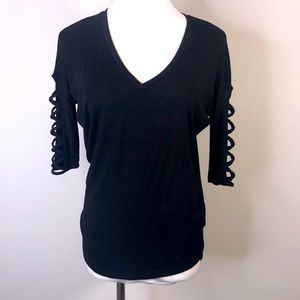Express dolman sleeve top with criss cross cutouts on sleeves
